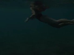 Enjoying underwater lesbian sex with a redhead