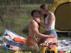 Horny young couple fucking in a tent