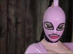 High heeled solo milf in latex dress and boots poses wearing a mask