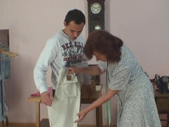 Older woman is measuring the pants of a younger person