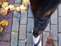 Crossdresser walks in public in latex tights and flip flops on a platform, showing off her sexy feet.