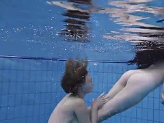 Enjoying underwater lesbian sex with a redhead