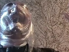 Breathing play with cling film in latex catsuit