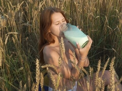 Charming redhead girl is running naked in the fields