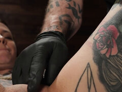 Tattooed girl is bound and fingered in BDSM dungeon