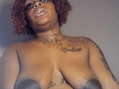 Black milf with large saggy breasts showing off her huge perky nipples