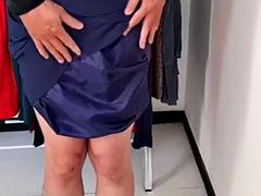Crossdressing wearing a satin secretary blouse and formal office skirt