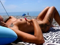 I watched a hot blonde with huge natural tits sunbathe naked at a nudist beach