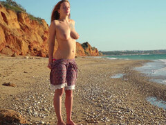 Sexy Elison with big natural tits caresses herself on the shore