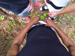 Threesome sucking cock in the park
