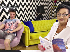 Watch this Russian granny with big tits get drilled in the living room with a young stud