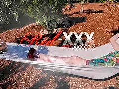 Red XXX stuffs her pussy with a toy in the hammock