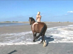 Alluring blonde chick Mila I rides a horse and removes her bikini top to show her knockers