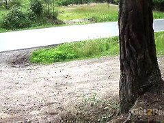 Watch this hot babe relieve herself next to a parked car in public, peeing and getting wet
