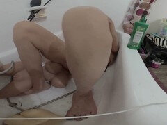 Lizzy Yum enjoys a slippery shower session with her sex doll toy while edging