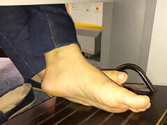 Sneaky peek at young feet under the desk (classic but still hot)