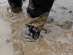 Two Thai men in high boots swim in the mud!