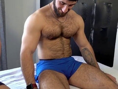 Unshaved muscle hunk gets a massage from his handsome buddy