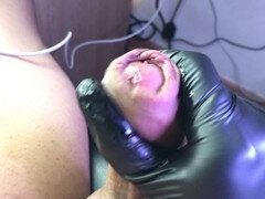 Precum dripping from pulled back foreskin in extreme close-up