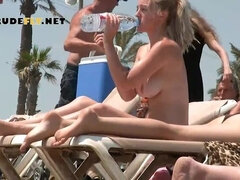 Bombastic young nudist babes sunbathe topless at the beach