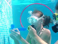 two red-hot lezzies playing with dildos in the pool