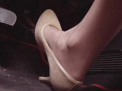 Driving Fast in Beige Pumps on Way to Airport