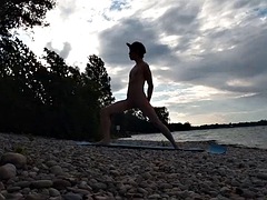 Slim nudist boy doing yoga naked on a nudist beach. Nude yoga video by John Artin, gay porn model, skinny naturist, twink, practice