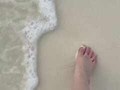 Running My Bare Feet on the White Beach Sand by the Ocean