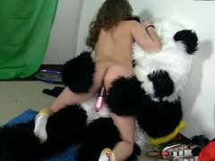 A man penetrates a skinny girl with a strap on on his panda suit