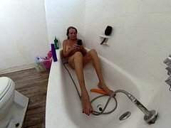 Lizzy Yum enjoying a solo session with her favorite toys in the shower and teasing herself