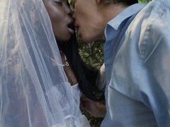 Black bride and a white groom are having sex in the woods