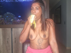 Topless Desi Squeezes Her Boobs as She Sucks and Deepthroats on a Banana