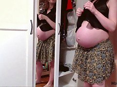 Hot super-sexy pregnant mom attempting on her narrow dress on huge pregnant belly