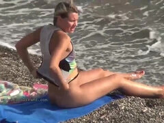 Nude girls are having tons of joy on the beach, while some people are gawping at them