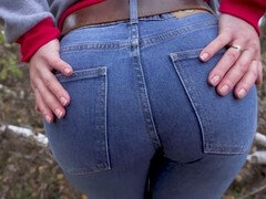 Sexy MILF teases her incredible booty in tight blue jeans outside
