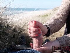 Milf Deluxemom gives a beach handjob while getting splooged on during dune fun