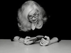 Vintage blonde granny in glasses reads exciting vintage sex book