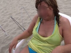 On the public beach, I show off my hairy pussy, tits, and more while having a good time.