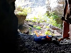 Neanderthal man masturbates his penis in a cave near a fire