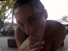 A brunette amateur is handling a cock in front of the camera