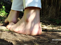 Beautiful mistress sits dirty on her feet