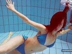 Fiery redhead in a stunning blue bikini shows off her incredible body