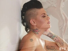 Tattooed brunette Jezebelle Bond teases and fingers herself