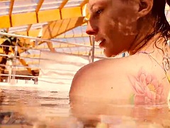 Baby floating in the swimming pool naked