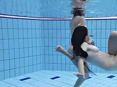 Enjoying underwater lesbian sex with a redhead