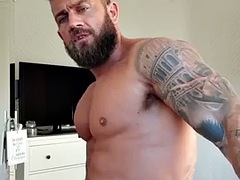 OF - Gareth Hulin, a tattooed and muscular bodybuilder, shows off