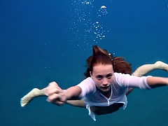 A girl from Tenerife swims naked underwater