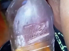 Pissing in a Large Juice Container