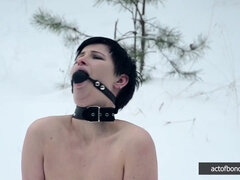 Naked barefoot Claudia chained in the snow