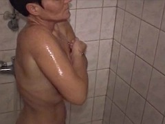 An old German lady with short hair having some fun with a long dong